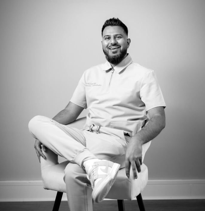 Dr Mohsin Ghor, founder of 53 Clinic, seated in clinic uniform